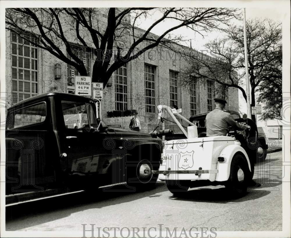 1966 Press Photo Traffic policeman watches wrecker hook-up truck. - hpa57544- Historic Images