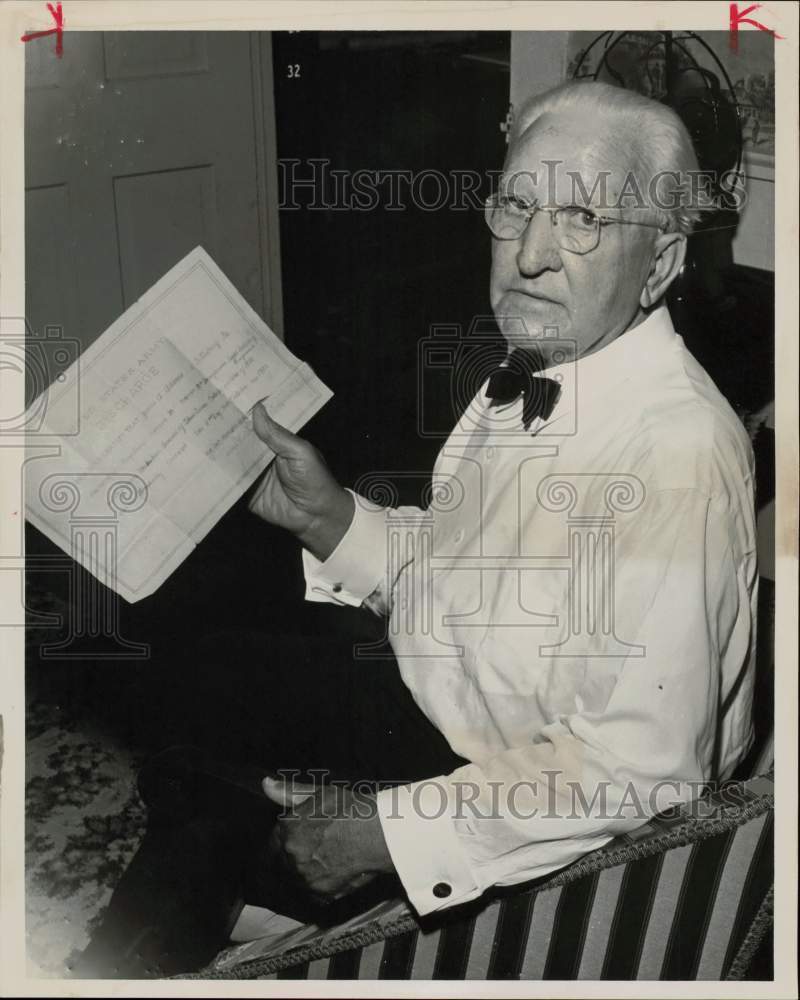 1960 Press Photo James Adams shows his faded discharge papers. - hpa58497- Historic Images