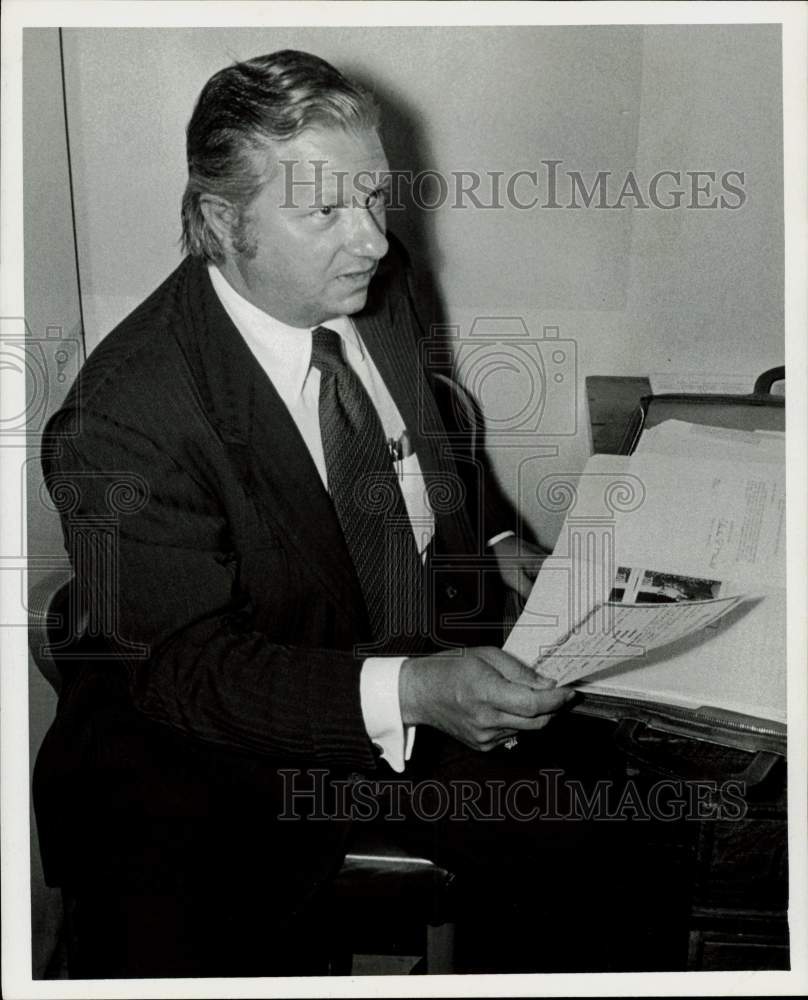 1972 Press Photo Jon Hughes, attorney, holds documents. - hpa72140- Historic Images