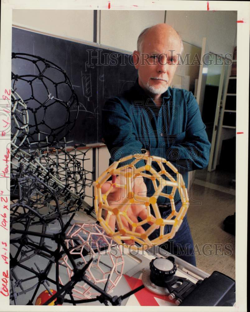 1991 Press Photo Dr. Richard Smalley of Rice University holds buckyball model.- Historic Images