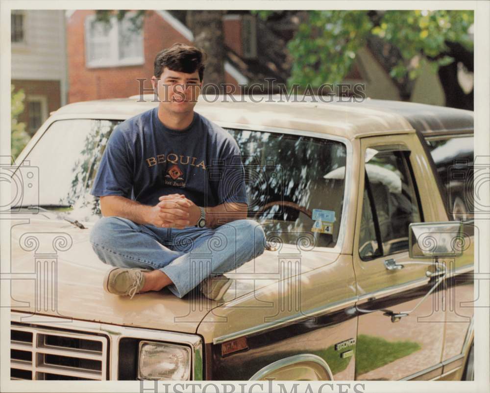1994 Press Photo Kai Bike sits on hood of his new used Bronco in Houston.