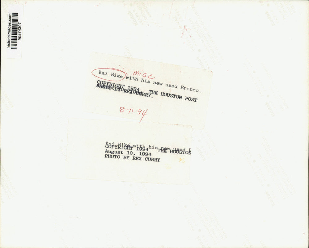 1994 Press Photo Kai Bike sits on hood of his new used Bronco in Houston.