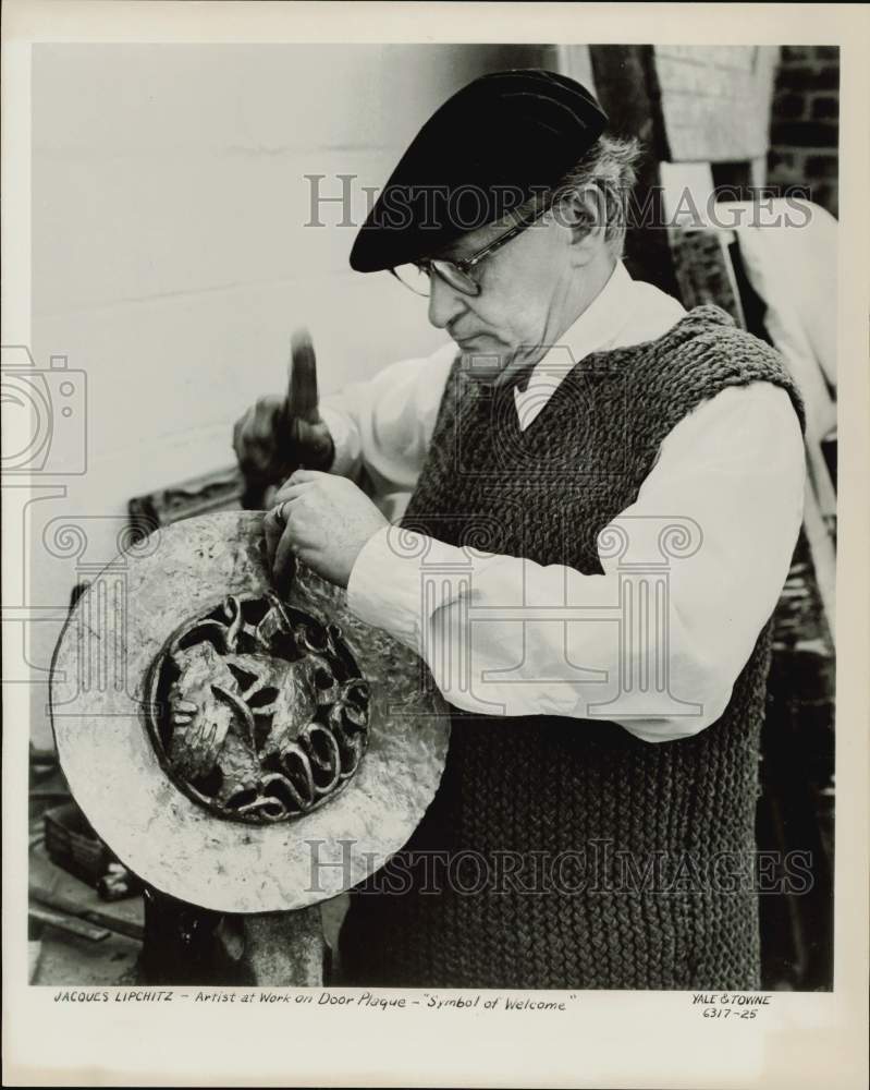 1958 Press Photo Jacques Lipchitz, sculptor, works on door plaque. - hpa75220- Historic Images