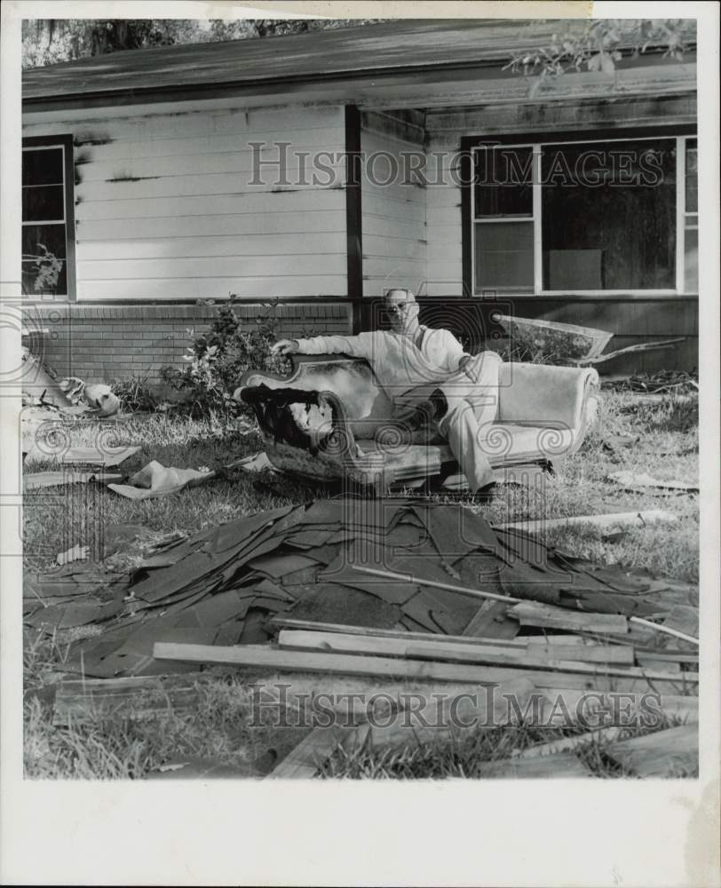 1959 Press Photo Robert McKeown sits on burned sofa in yard of burned home.- Historic Images