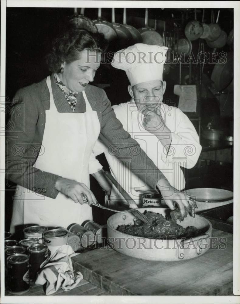 1959 Press Photo Independent oilman Ken Regan cooking with a woman - hpa78765- Historic Images