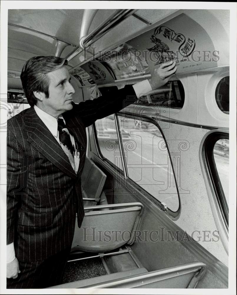 1973 Press Photo Dr. Albert Randall, Houston City Health Director, shows bus ad- Historic Images