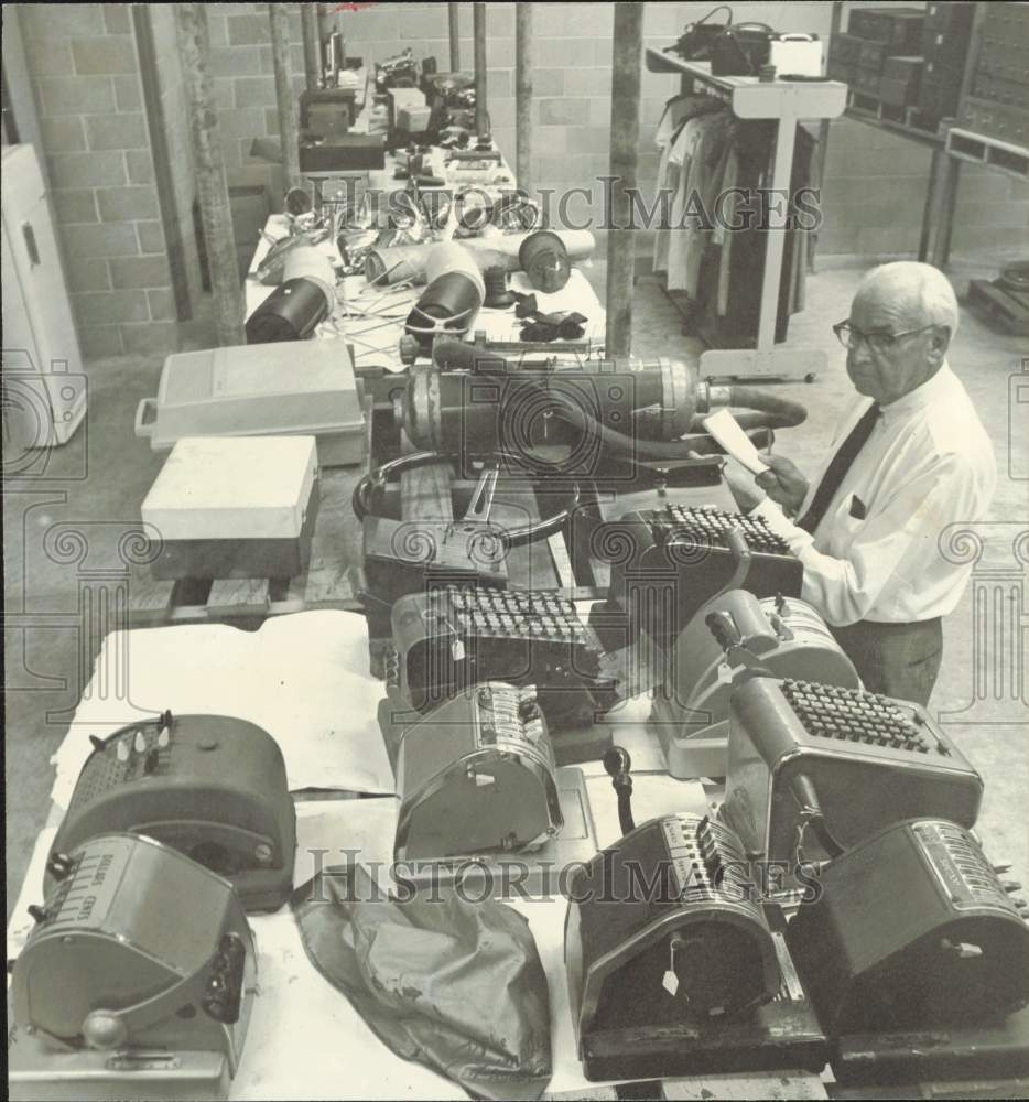 1969 Press Photo E.A. Newgren looks over office equipment in his Houston garage.- Historic Images