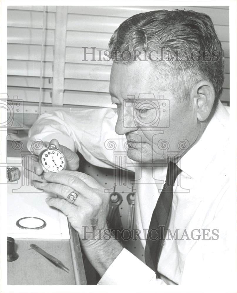1964 Press Photo Walter C. Russell, watchmaker, inspects pocket watch- Historic Images