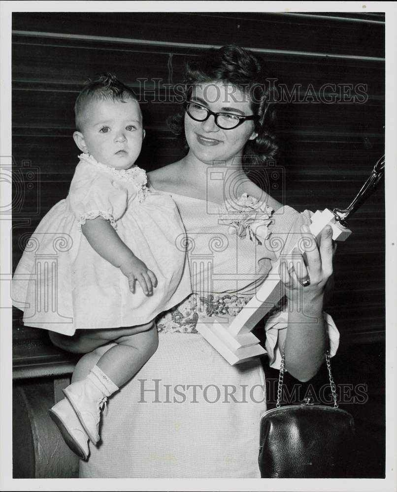 1960 Press Photo Maratha Posey holds child and trophy. - hpa81314- Historic Images