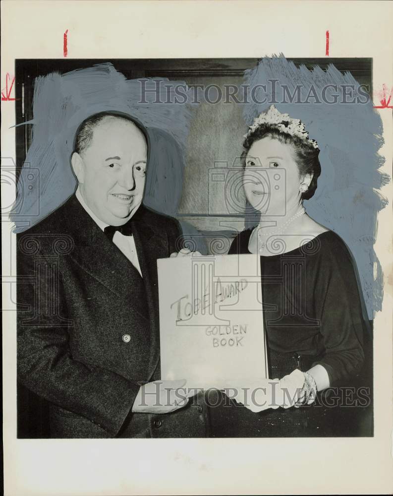 1956 Press Photo B. Earl Puckett and Mrs. Davis hold Tobe Award Golden Book.- Historic Images