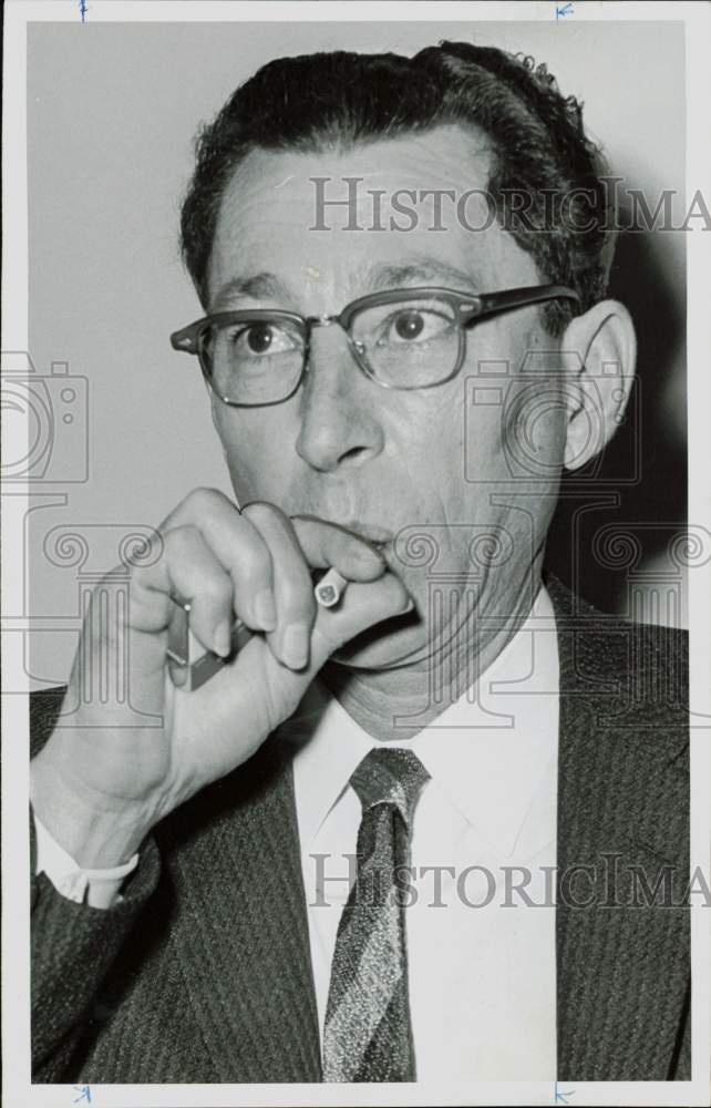 1961 Press Photo Walter Carl Sanders, Baytown banker, puffs on cigarette.- Historic Images