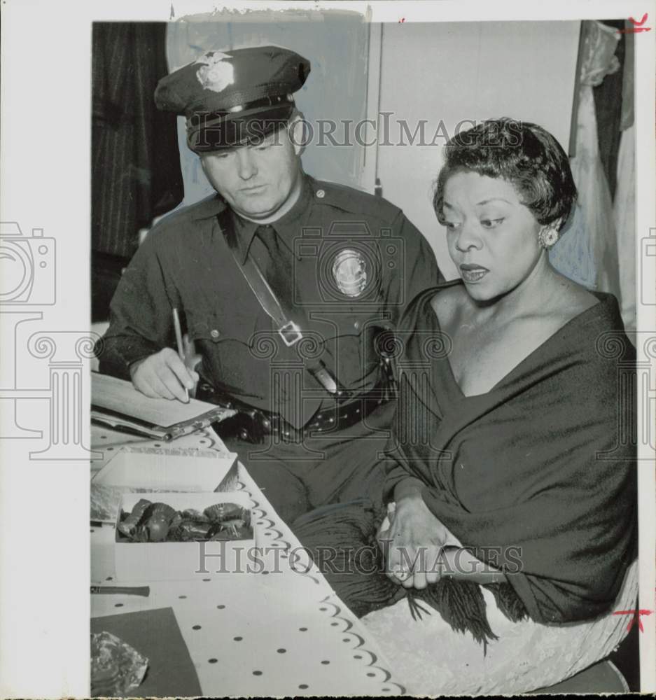 1957 Press Photo Police officer questions woman about a crime - hpa83754- Historic Images