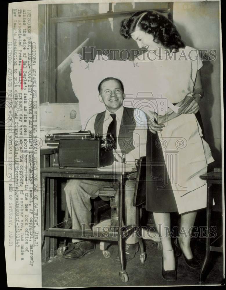 1948 Press Photo "Mally Gesell" walks past AP writer Hal Boyle's desk in NY.- Historic Images