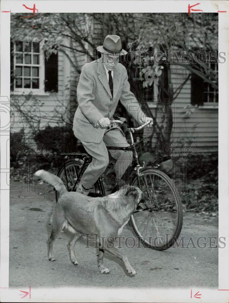 1955 Press Photo Dr. Paul Dudley rides bike near his Belmont, MA home.- Historic Images