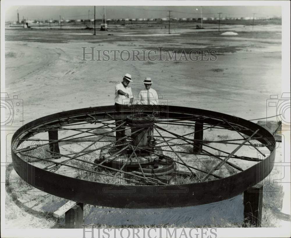 1955 Press Photo Men inspect equipment at oil and gasoline field. - hpa84597- Historic Images