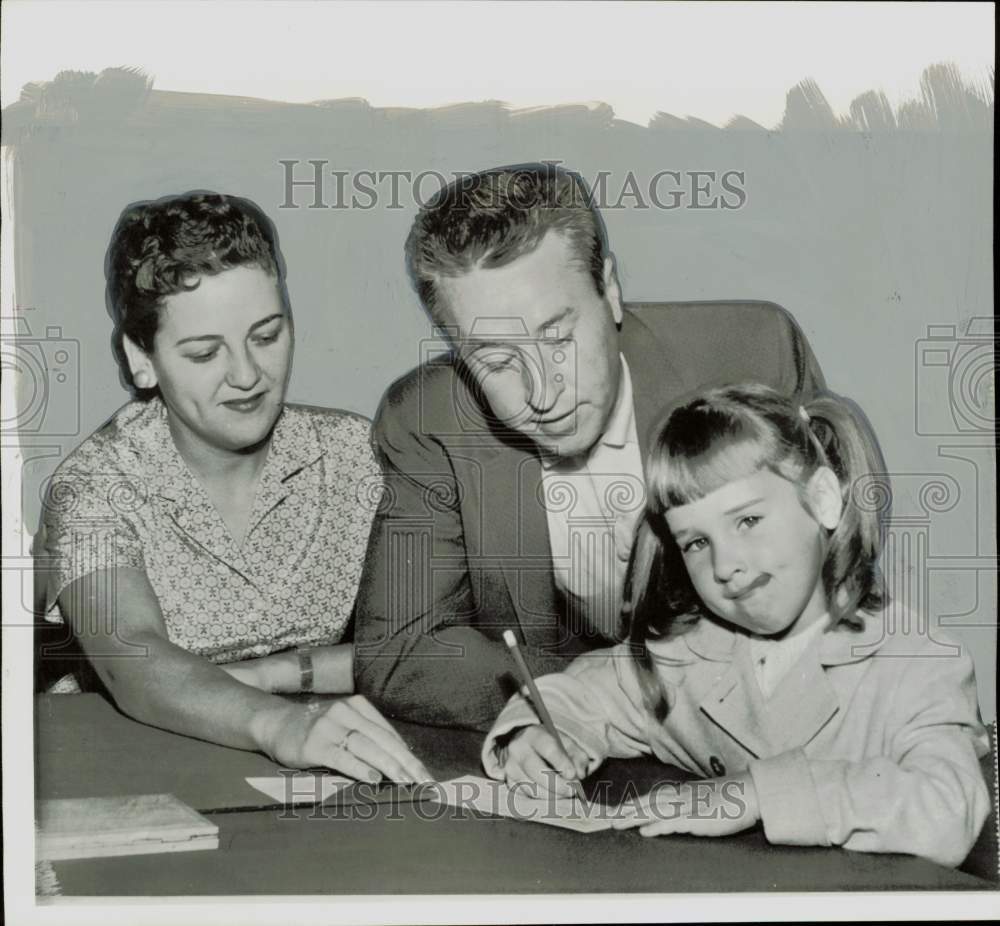 1956 Press Photo Parents watch Georgia Gobel fill out Social Security form- Historic Images