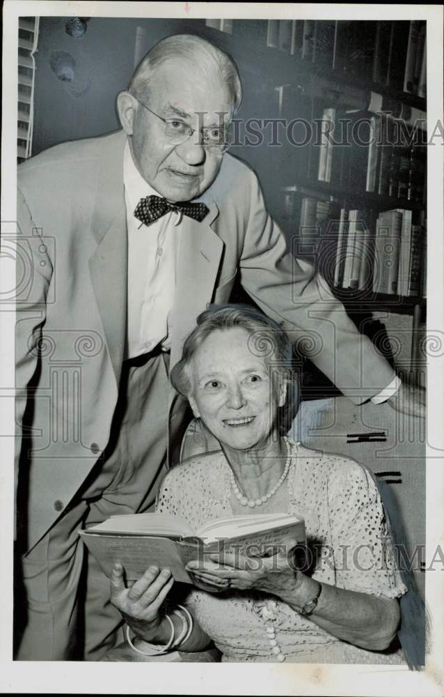 1955 Press Photo Dr. Winfred and Mrs. Garrison look through a book. - hpa84685- Historic Images