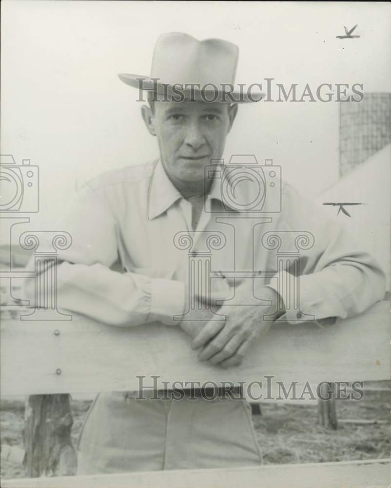 1955 Press Photo Houston Post Columnist H.B. Fox leans against fence in Texas.- Historic Images