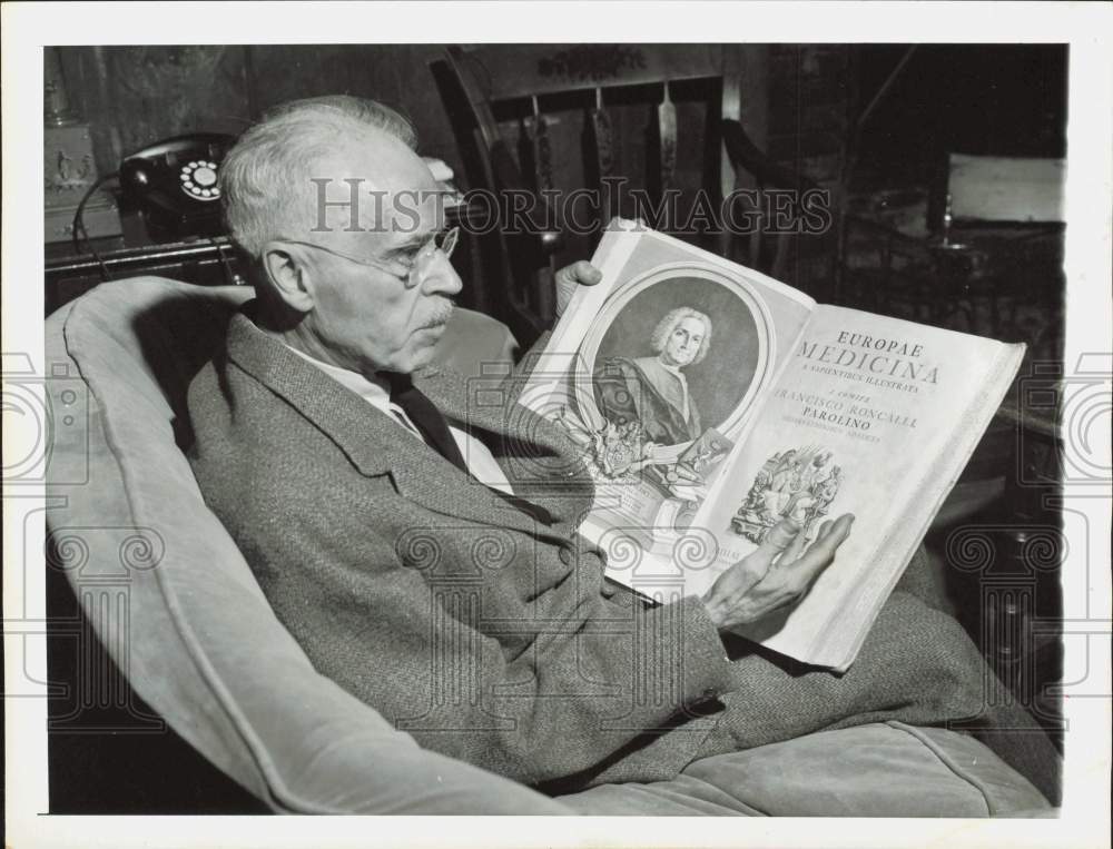 1955 Press Photo Dr. White relaxes with book &quot;Europae Medicina&quot; - hpa85790- Historic Images