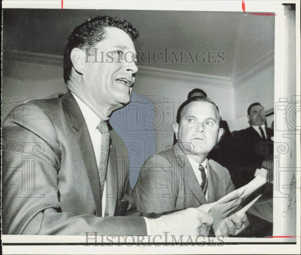 1966 Press Photo Ralph Wilson watches Joe Foss announce resignation.- Historic Images