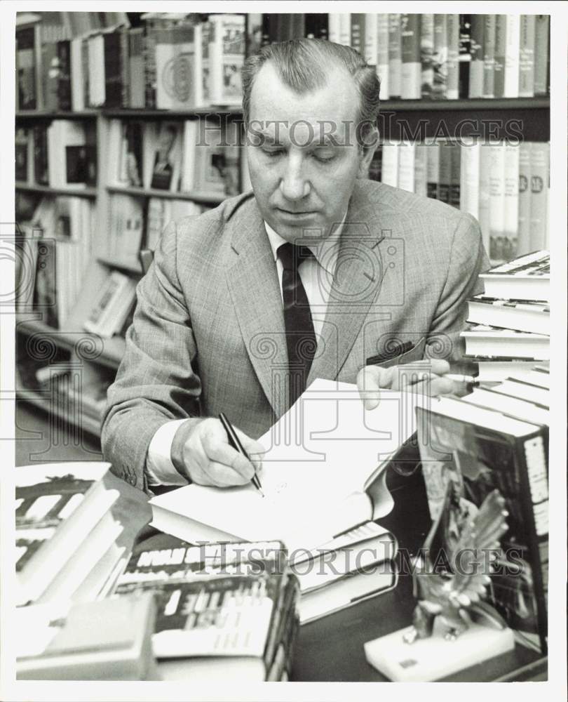 1966 Press Photo Author Cornelius Ryan signing a book - hpa86508- Historic Images