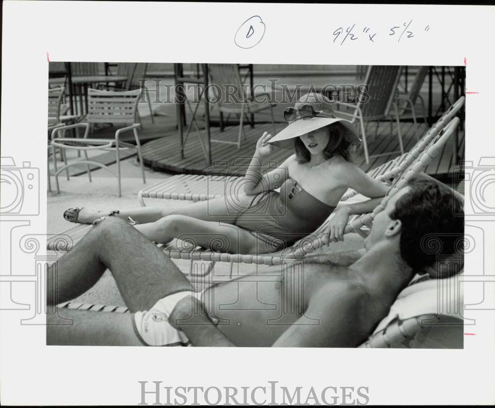 1979 Press Photo Couple Sunbathing in Poolside Chairs - hpa88007- Historic Images