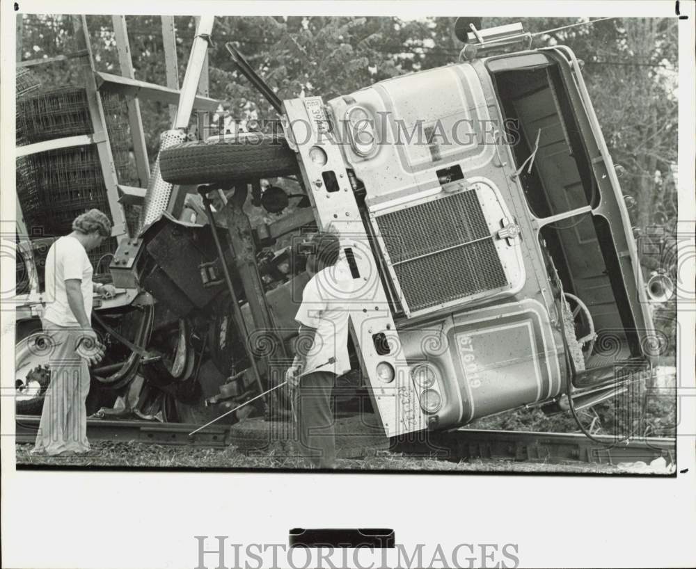 1976 Press Photo Tractor Trailer Truck Flipped in Accident with Freight Train- Historic Images