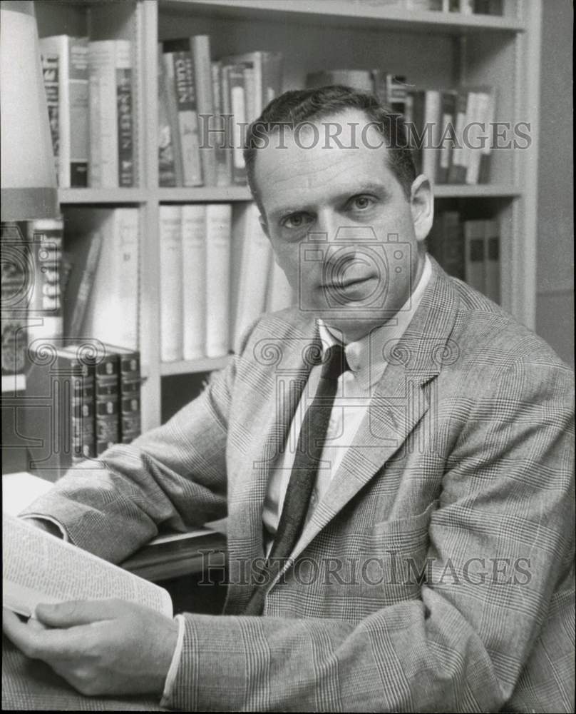 1957 Press Photo Frank H. Creire holds a book in his Houston office - hpa93008- Historic Images