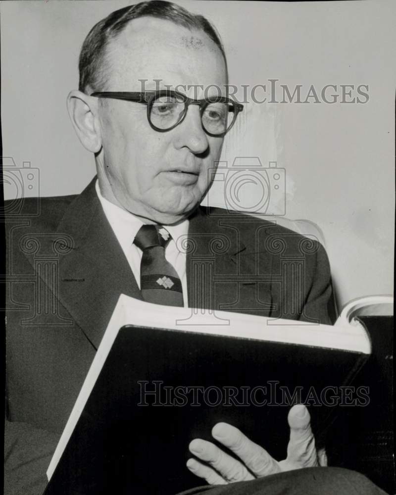 1955 Press Photo Engineer Mason Graves Lockwood studies map book. - hpa93174- Historic Images