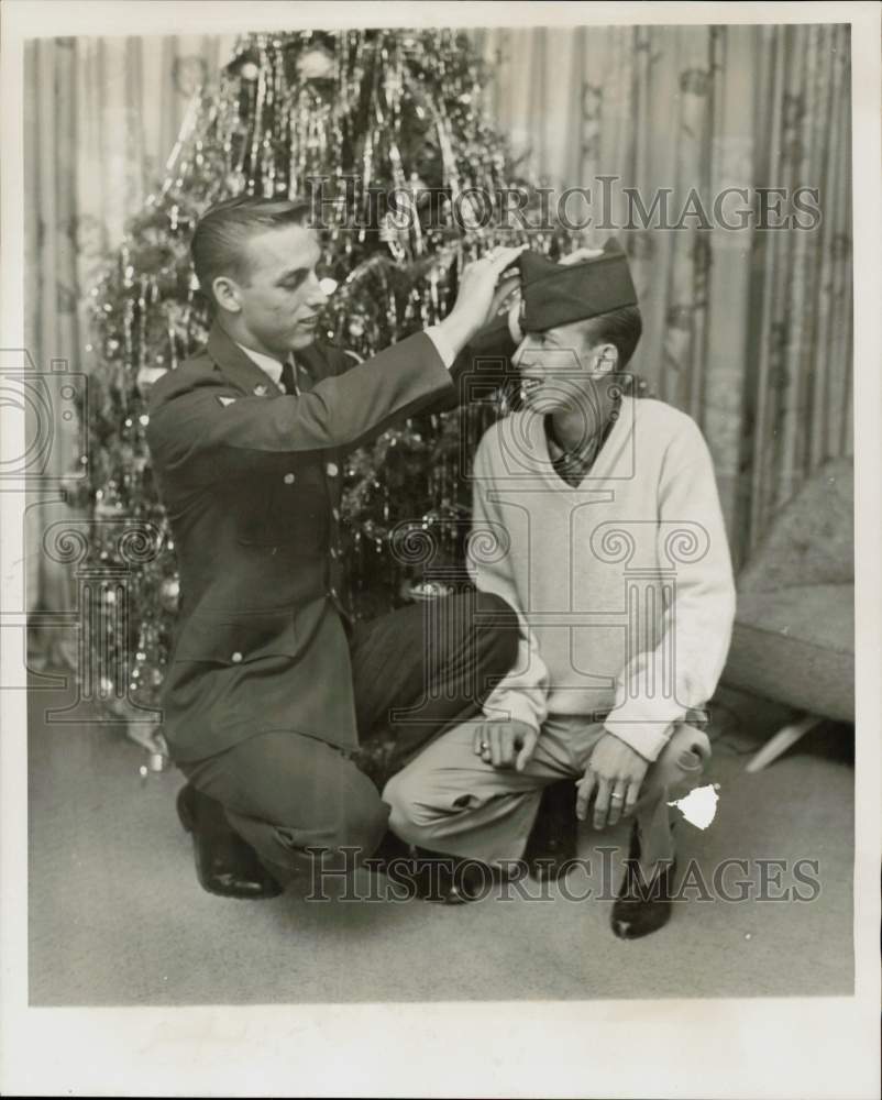 1965 Press Photo Gregory Schroen, Army PFC, places cap on twin Tim at their home- Historic Images