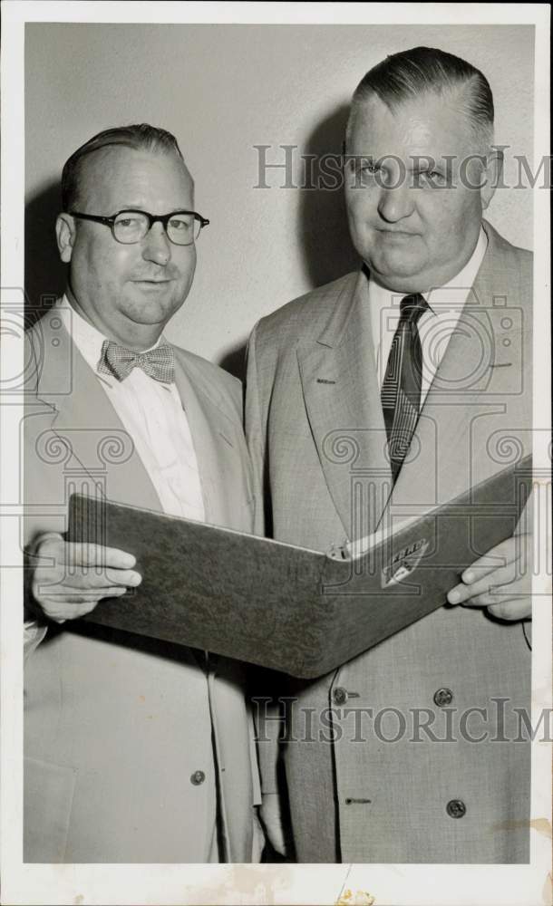 1953 Press Photo Thad Felton and Ford dealer views document. - hpa94346- Historic Images