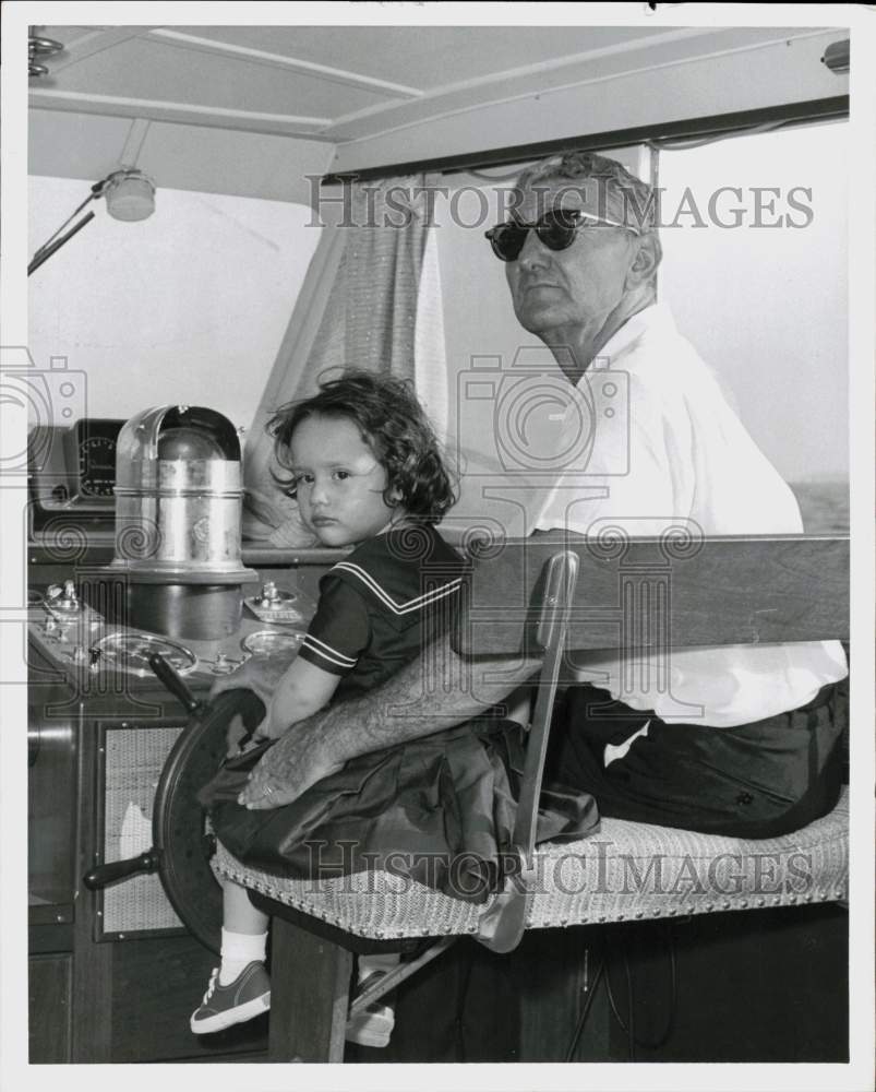 1961 Press Photo Michel Mellinger and Gwen Frazier sit in boat&#39;s captain chair.- Historic Images