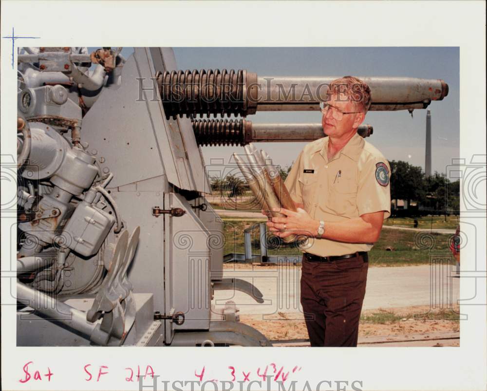 1990 Press Photo Jim Franz holds Battleship Texas 40mm dummy rounds. - hpa96189- Historic Images