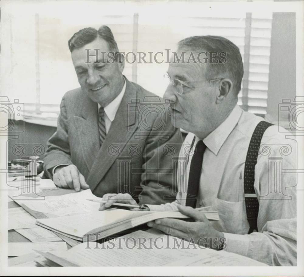 1957 Press Photo Cutrer and Roy Oakes confer over bond issue. - hpa97278- Historic Images