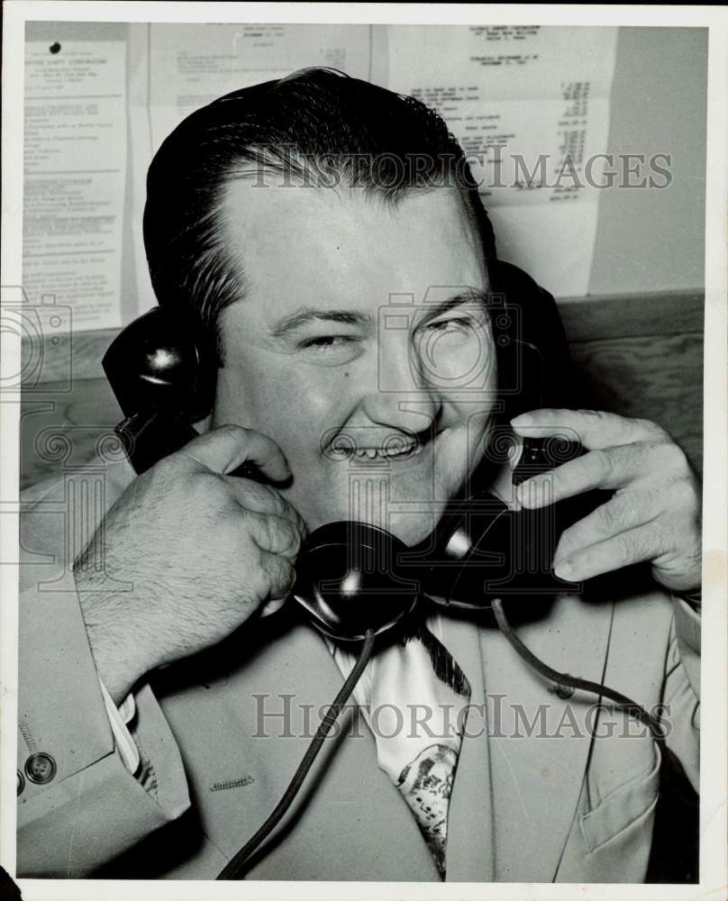 1960 Press Photo Neil Reese, Houston insurance man, talks on two phones.- Historic Images