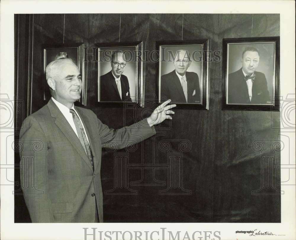 1960 Press Photo Rex Baker admires portraits in Southwestern Directors&#39; Room.- Historic Images