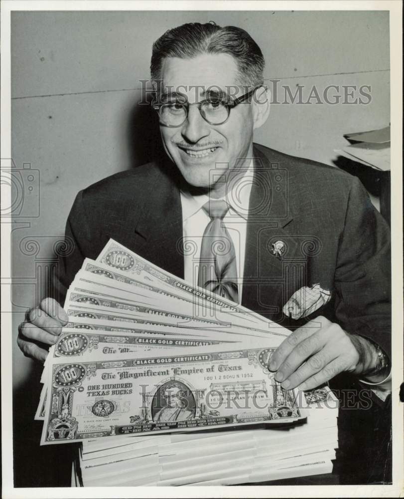 1955 Press Photo Luke Kaiser of Premier Printing holds Black Gold Certificates.- Historic Images