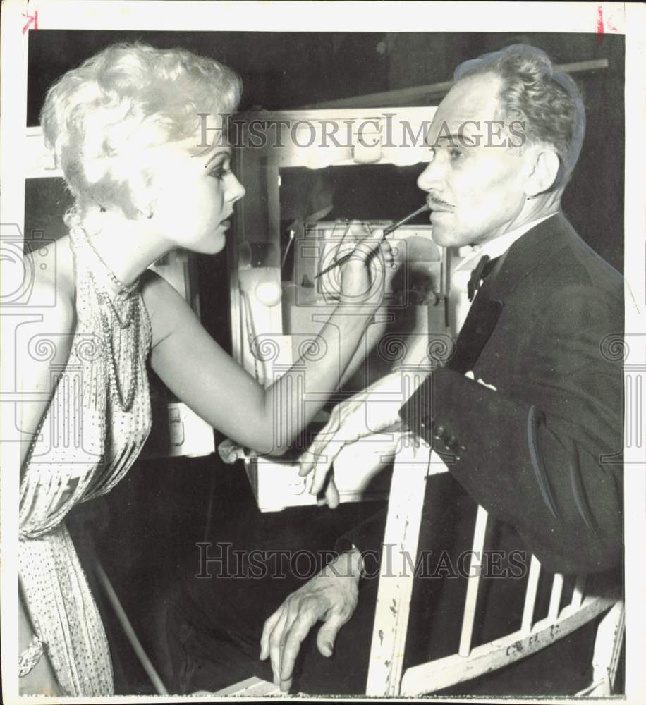 1957 Press Photo Actress Kim Novak Paints Mustache on Man - hpp40197- Historic Images