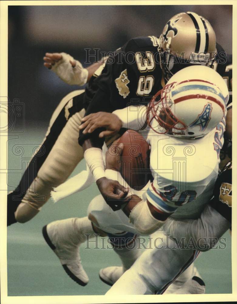 1987 Press Photo Oiler Mike Rozier stopped by Saints&#39; Brett Maxie, football game- Historic Images