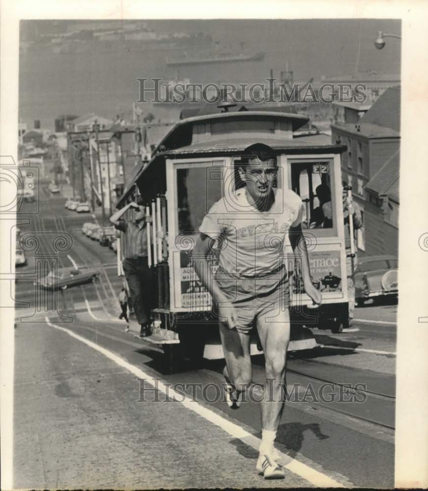 1966 Press Photo Ron Clarke of Texas runs uphill next to street car - hps02173- Historic Images