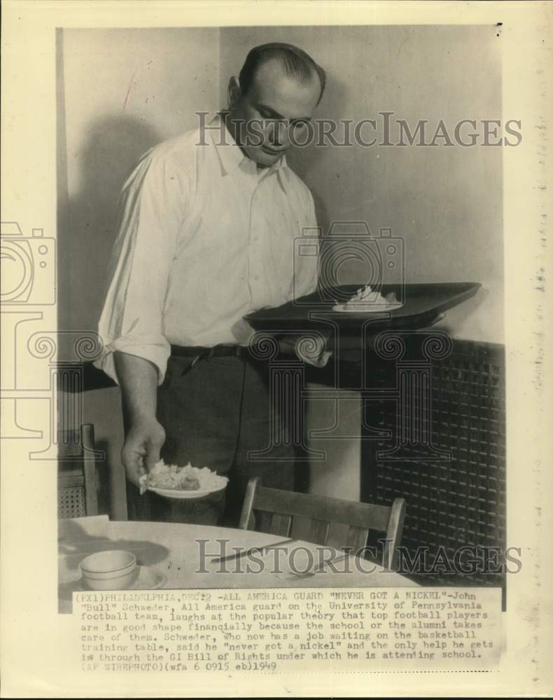 1949 Press Photo Football player John Schweder waits tables at training camp.- Historic Images