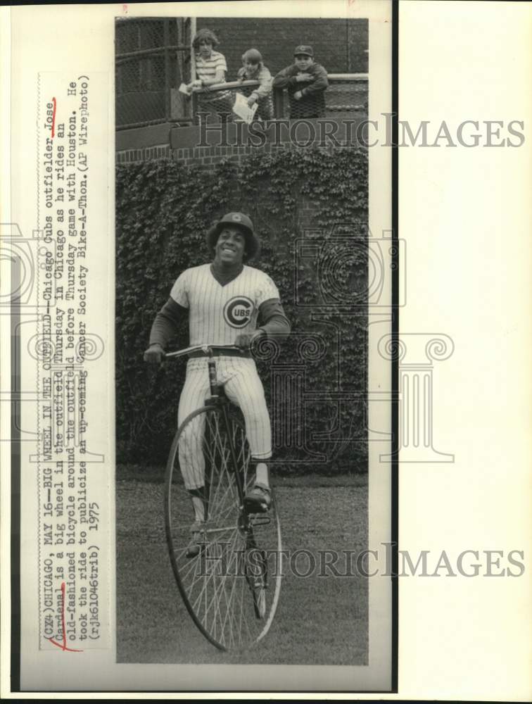 1975 Press Photo Jose Cardenal rides big wheel in Chicago Cubs outfield.- Historic Images