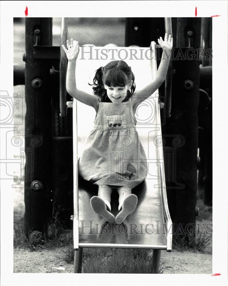 1983 Press Photo A child on a slide - hps10244- Historic Images