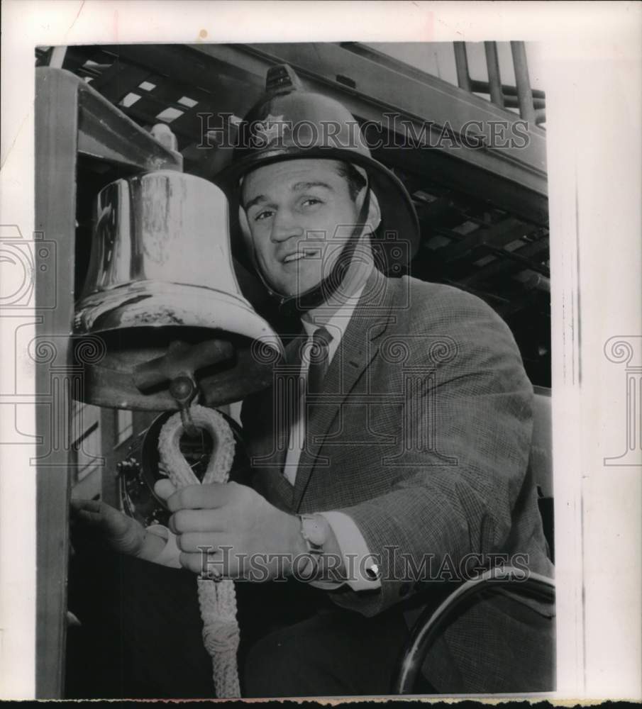 1961 Press Photo Paul Pender wires fireman&#39;s hat and rings firebell. - hps13414- Historic Images