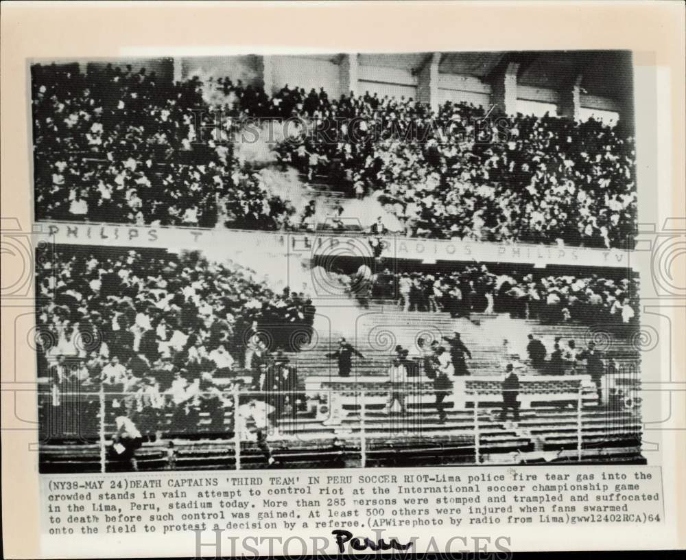 1964 Press Photo Police fire tear gas into Lima, Peru rioted stadium.- Historic Images