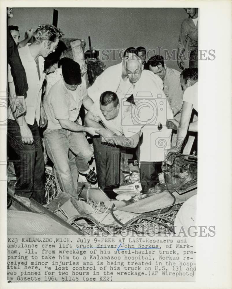 1964 Press Photo John Norkus freed from truck wreckage by rescuers in Kalamazoo.- Historic Images