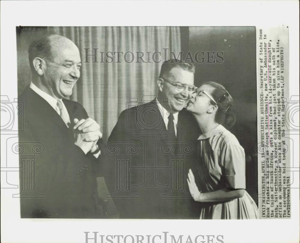 1961 Press Photo Dean Rusk grins as Joseph Satterthwaite kissed by daughter.- Historic Images