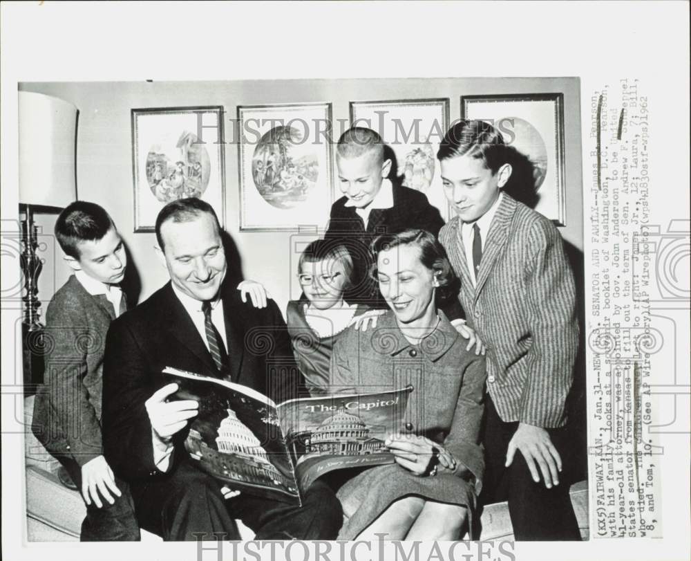 1962 Press Photo Senator James Pearson and family look at Washington, D.C. book.- Historic Images