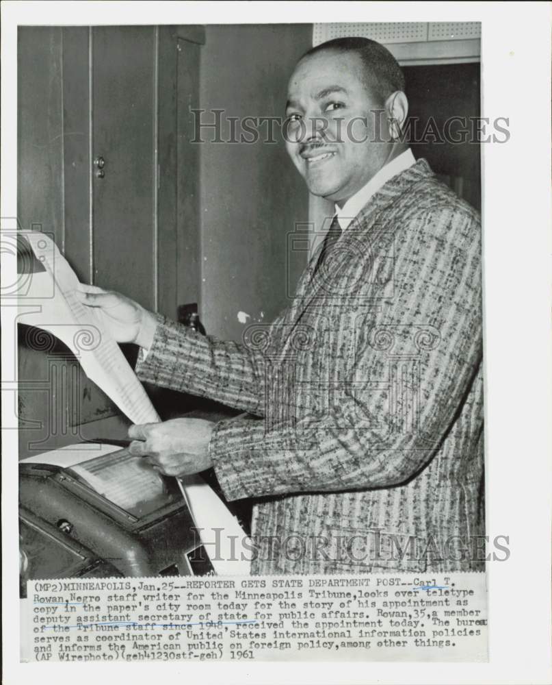 1961 Press Photo Carl Rowan, Minneapolis Tribune writer, views teletype copy.- Historic Images