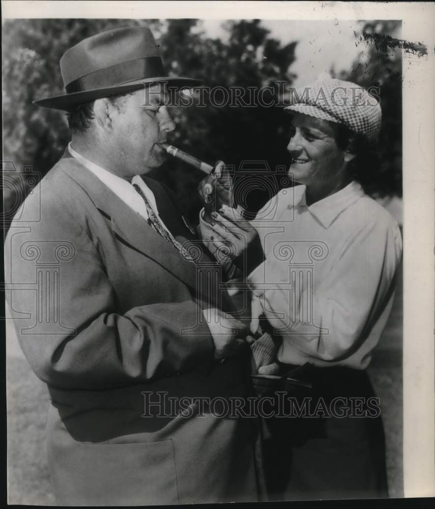 1956 Press Photo Babe Zaharias, Golfer lights man's cigar - hpx00768- Historic Images